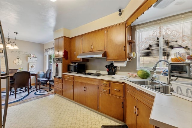 1120 Henderson Ave, Canton Twp, PA 15301 - kitchen with white oven, under cabinet range hood, a sink, light countertops, and cooktop