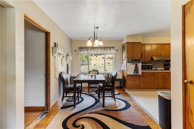 tiled dining space featuring a notable chandelier