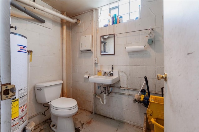 1120 Henderson Ave, Canton Twp, PA 15301 - full bathroom with water heater, toilet, unfinished concrete floors, a shower with shower curtain, and concrete block wall