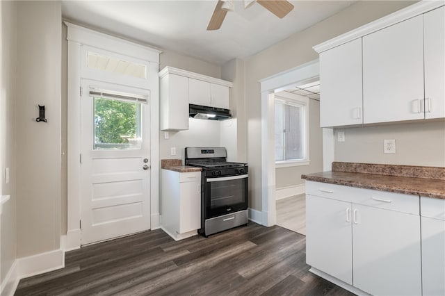 kitchen featuring dark wood-type flooring, white cabinetry, gas stove, and ceiling fan