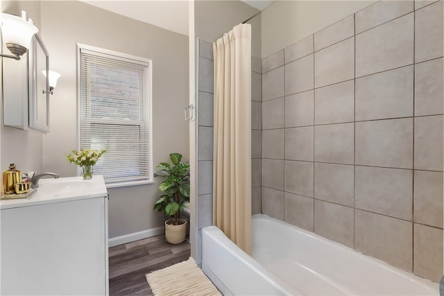 bathroom with vanity, wood-type flooring, and shower / tub combo