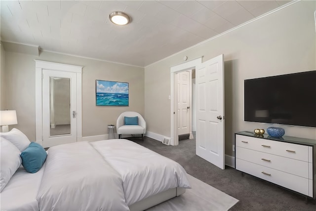 bedroom featuring ornamental molding and dark colored carpet