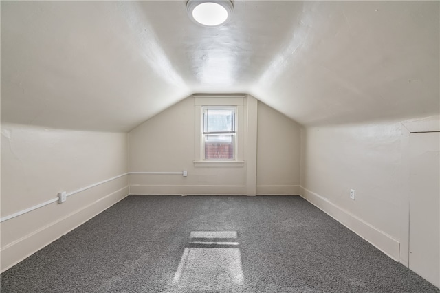 bonus room with carpet and vaulted ceiling