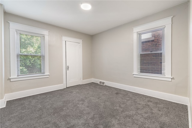 empty room featuring dark carpet