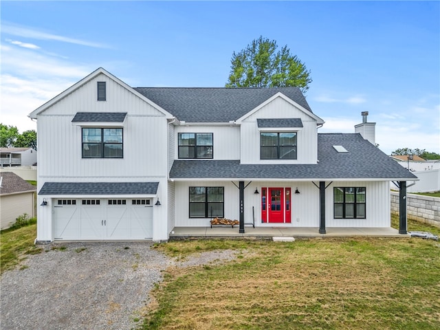 modern farmhouse with a garage and a front lawn