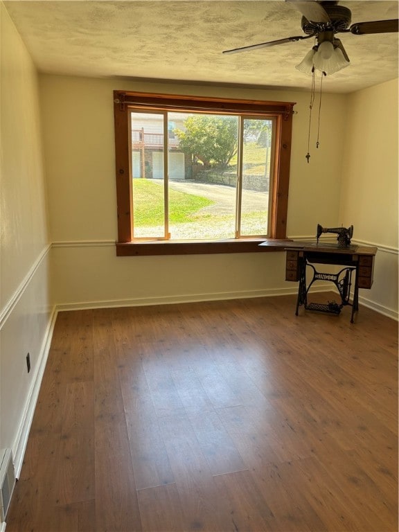 empty room featuring hardwood / wood-style flooring and ceiling fan