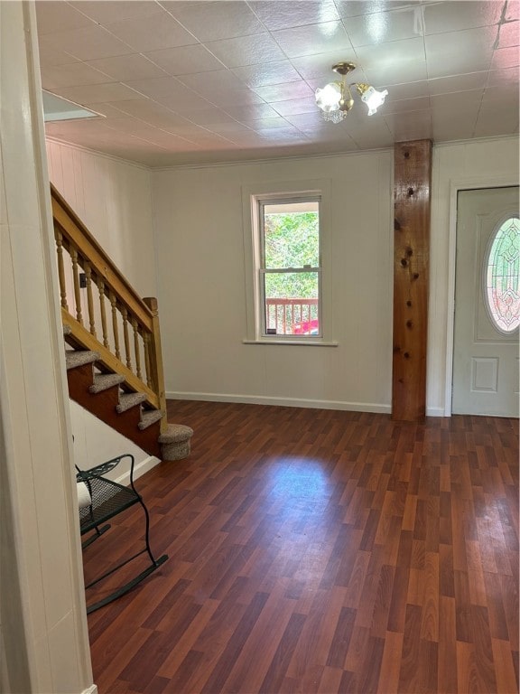 foyer entrance featuring dark hardwood / wood-style flooring and a notable chandelier