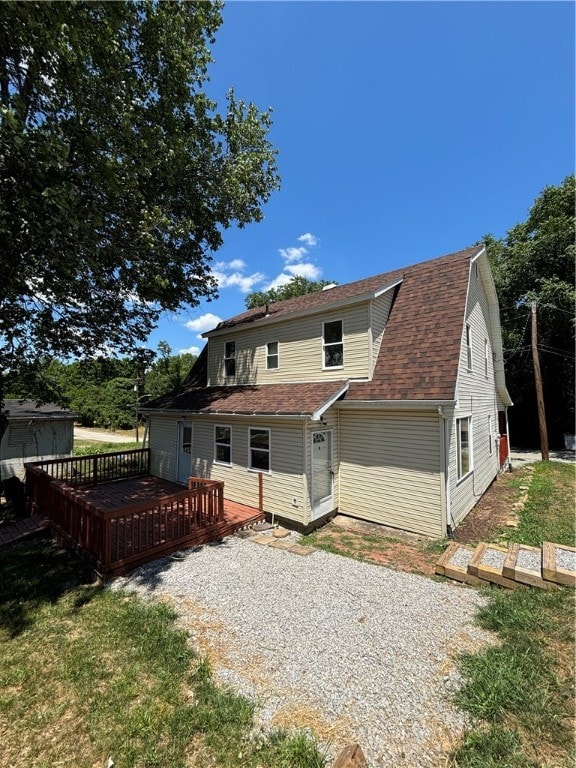 rear view of house with a wooden deck