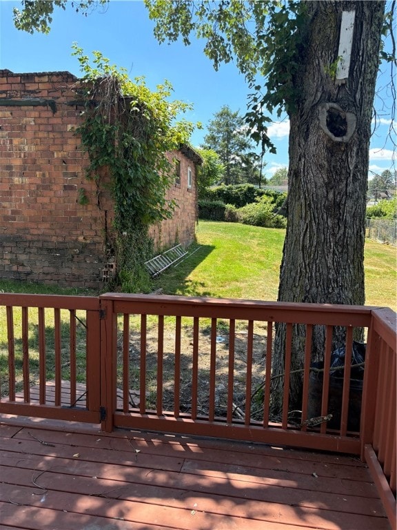 wooden terrace with a lawn