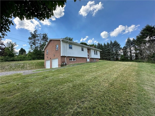 exterior space with a garage and a lawn