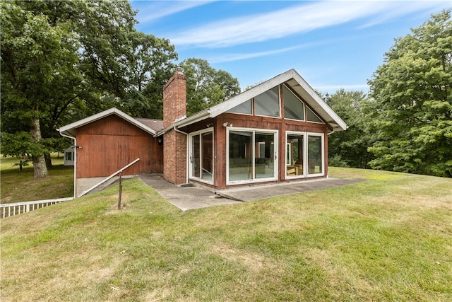 rear view of property featuring a patio area and a yard