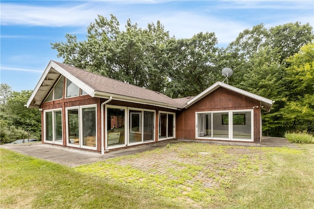 rear view of property featuring a patio area and a yard