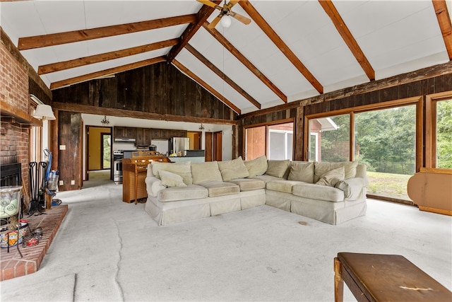 carpeted living room featuring wood walls, beam ceiling, and high vaulted ceiling