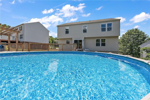 view of swimming pool with a pergola and a deck