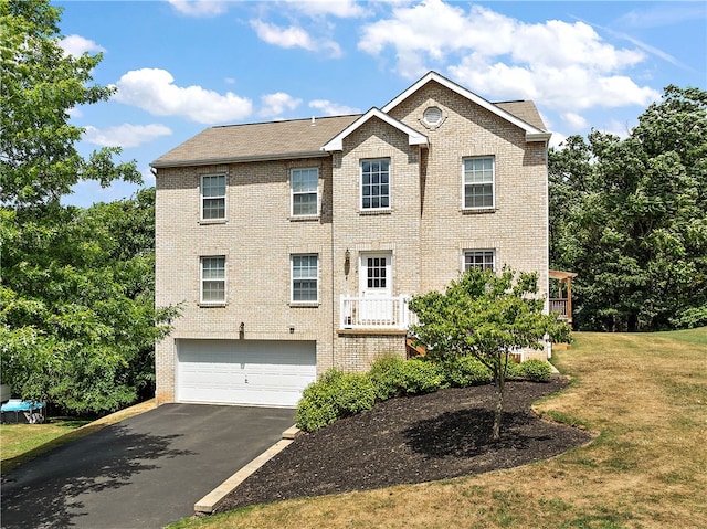 view of front of home with a garage and a front lawn