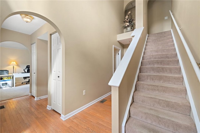 stairway with hardwood / wood-style floors