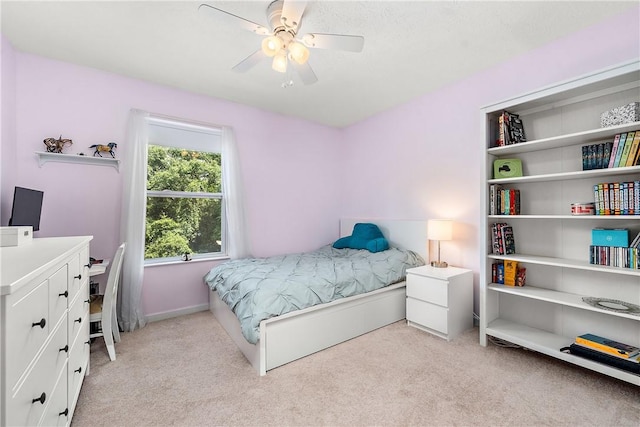 bedroom featuring light carpet and ceiling fan