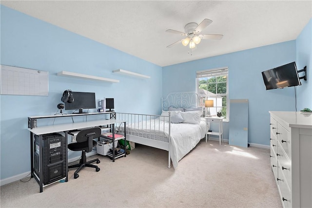 bedroom featuring light colored carpet and ceiling fan