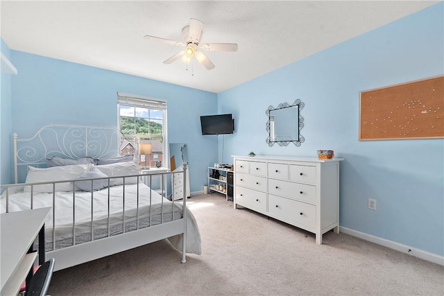 bedroom featuring ceiling fan and light colored carpet