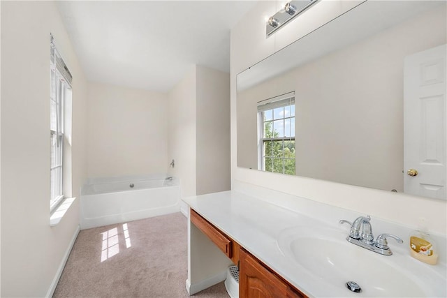 bathroom featuring vanity and a bath