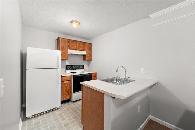 kitchen with sink, white appliances, kitchen peninsula, and a textured ceiling