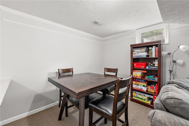 dining space with crown molding, carpet flooring, and a textured ceiling