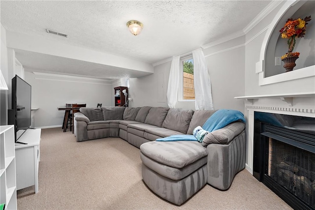 living room featuring ornamental molding, carpet flooring, and a textured ceiling