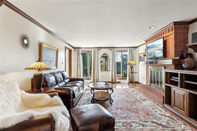 living room featuring a brick fireplace and ornamental molding