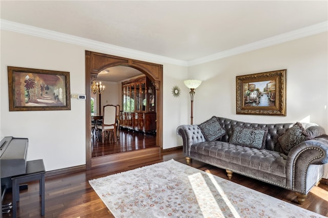 living room with dark hardwood / wood-style floors, a notable chandelier, and ornamental molding