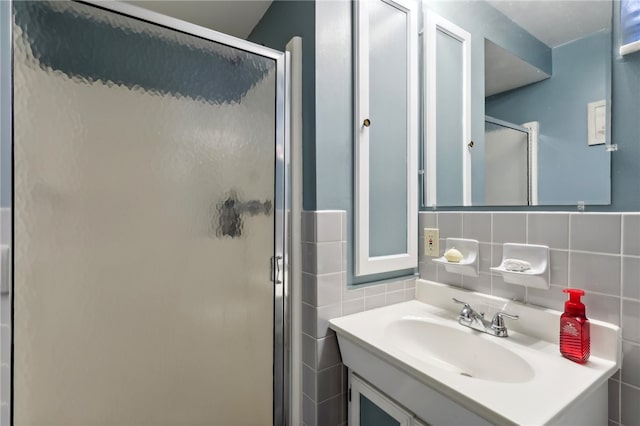 bathroom featuring vanity, walk in shower, tile walls, and backsplash