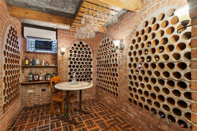 wine cellar with brick wall, beamed ceiling, and a wall mounted AC