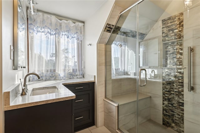 bathroom with tile patterned floors, vaulted ceiling, vanity, and an enclosed shower