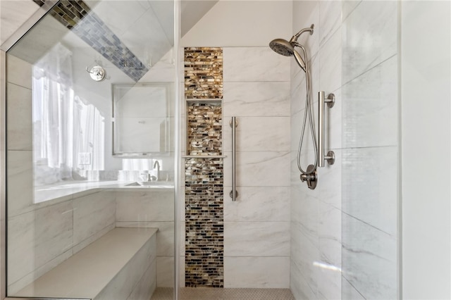 bathroom featuring sink and a tile shower