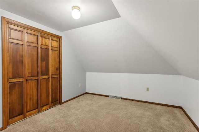 additional living space with lofted ceiling and light colored carpet