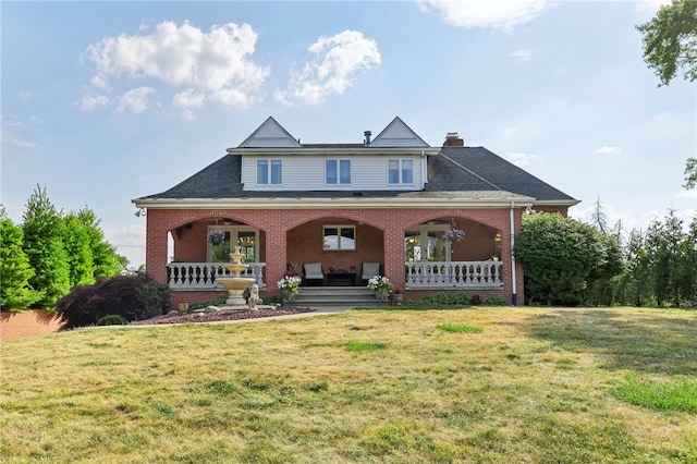 view of front of house with a porch and a front yard