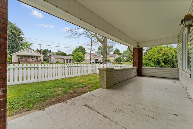 wooden terrace with a lawn