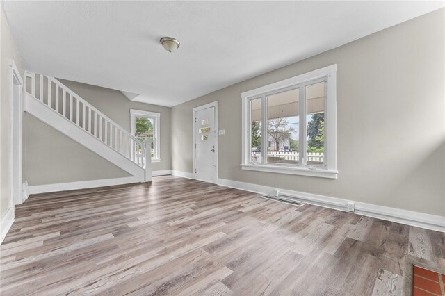 unfurnished living room with hardwood / wood-style flooring