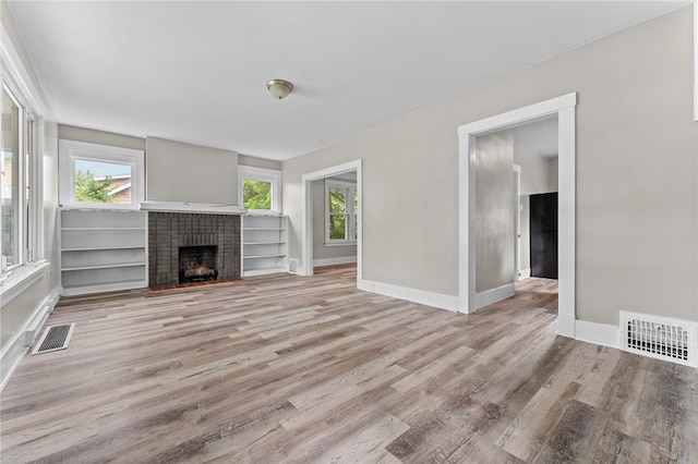 unfurnished living room featuring light hardwood / wood-style floors and a fireplace