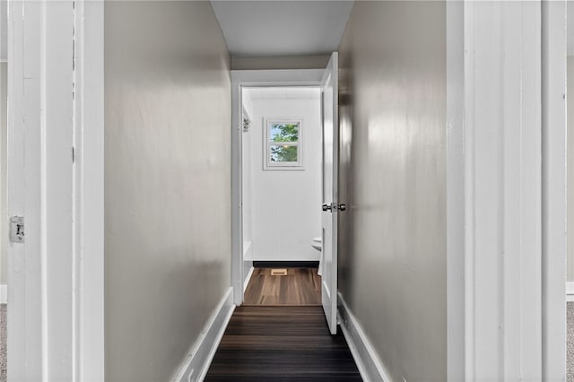 hallway with dark wood-type flooring