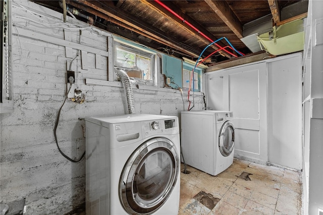 washroom with light tile patterned flooring and separate washer and dryer