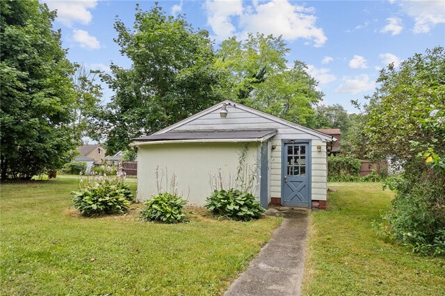 view of outbuilding with a lawn