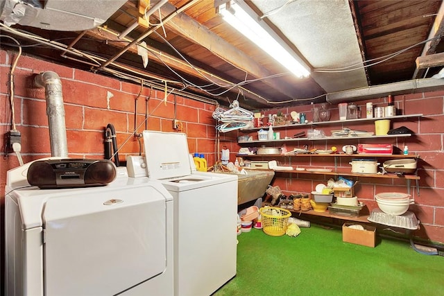 clothes washing area featuring carpet, separate washer and dryer, and sink