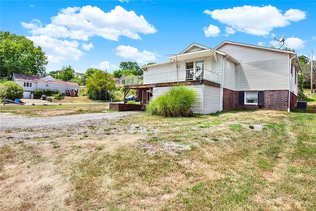 view of home's exterior with a lawn and central AC