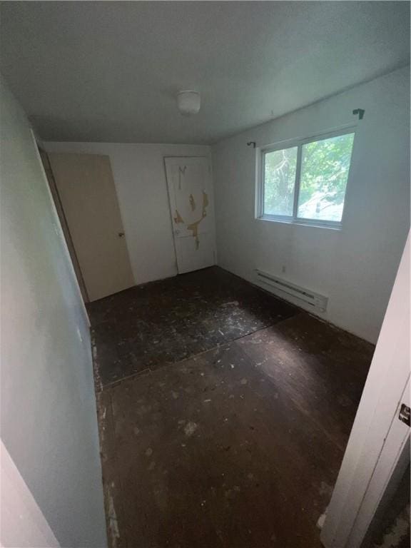 spare room featuring a baseboard heating unit