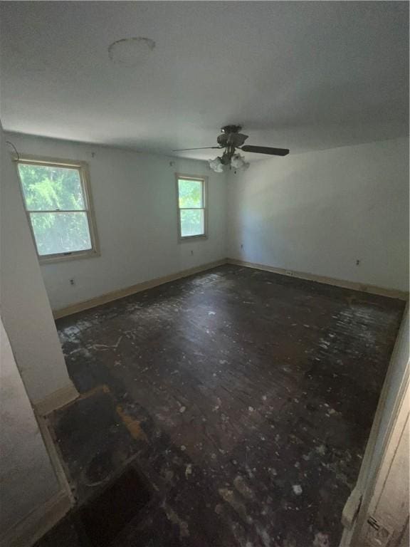 spare room featuring ceiling fan and a healthy amount of sunlight