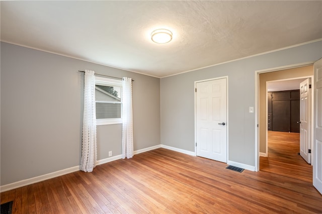 unfurnished bedroom with hardwood / wood-style floors and a closet