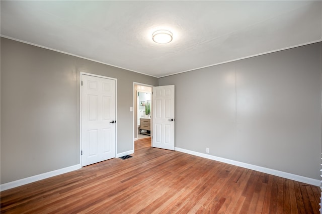 unfurnished room with wood-type flooring