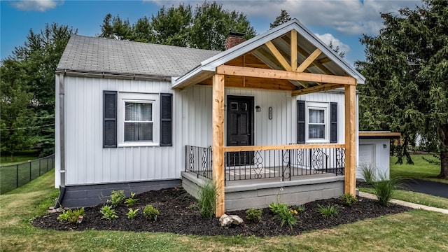 view of front of house with covered porch and a front yard