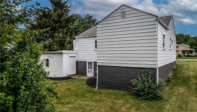 view of home's exterior with a yard