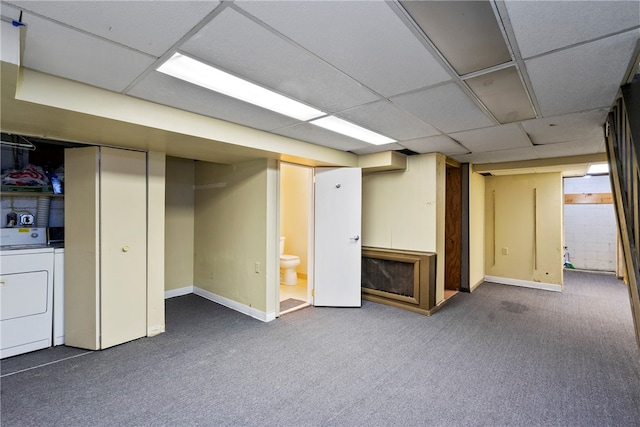 basement featuring washer and dryer, a paneled ceiling, and dark carpet